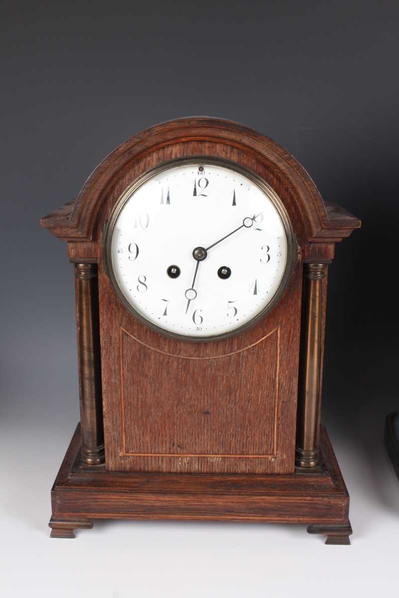 An early 20th century oak mantel clock with eight day movement striking on a gong, the white - Image 2 of 27