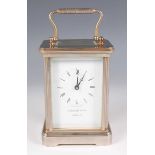 A late 20th century Garrard & Co plated brass corniche cased carriage timepiece, the signed white