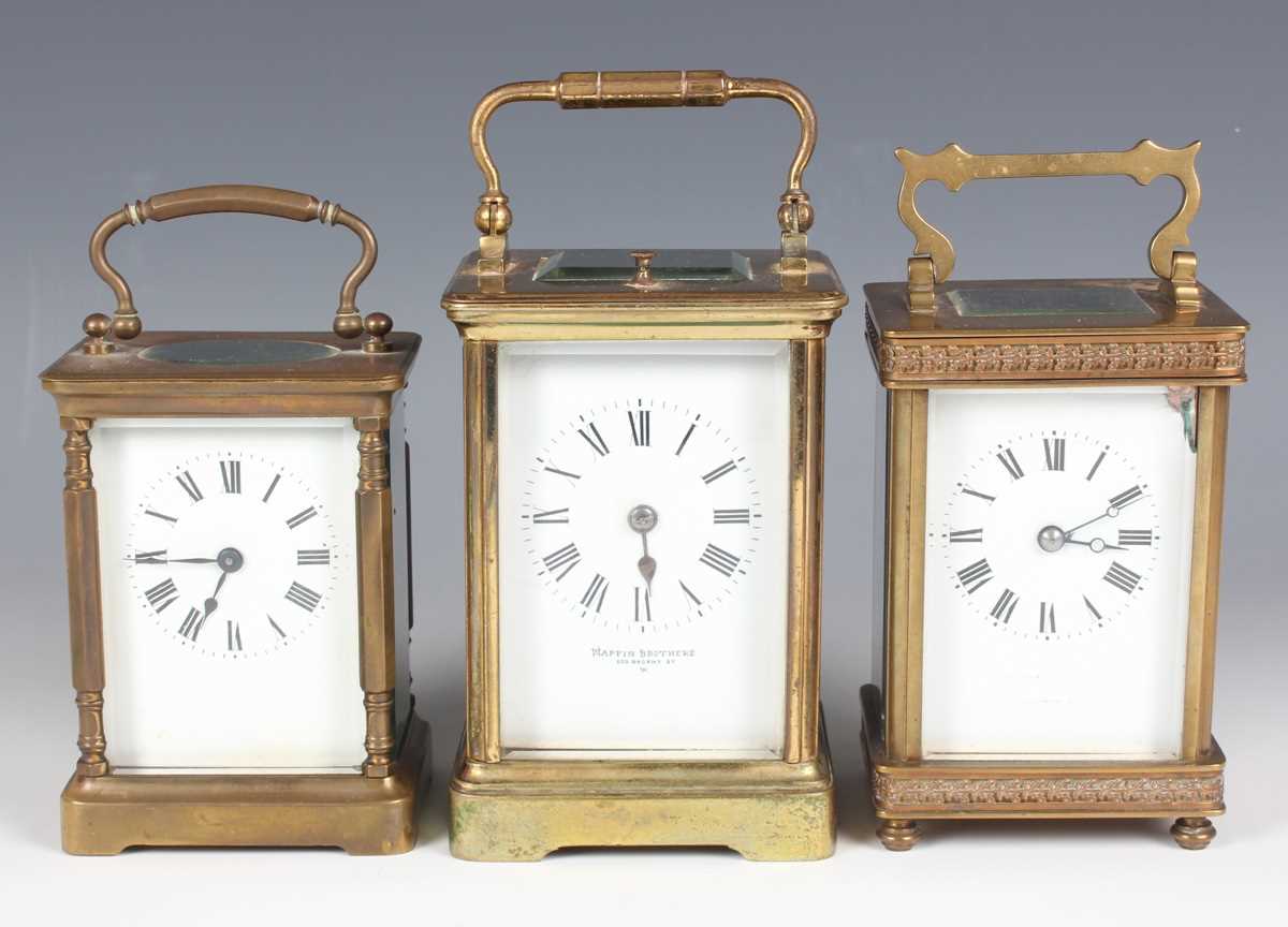 A 20th century lacquered brass corniche cased carriage clock with eight day movement striking and