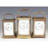 A 20th century lacquered brass corniche cased carriage clock with eight day movement striking and