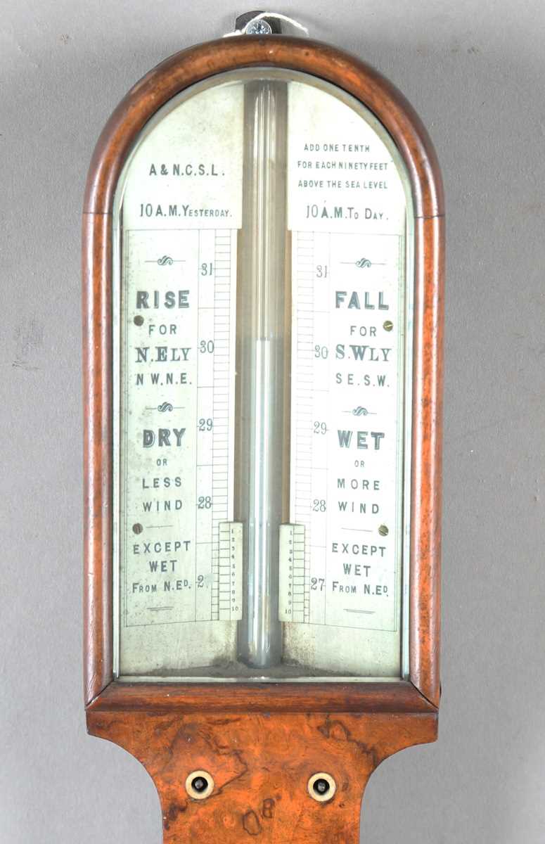 A late Victorian walnut stick barometer, the arched ivorine dial with Vernier scale and inscribed 'A