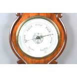 A Victorian walnut cased wheel barometer with opaline glass dial and thermometer dial, the case with