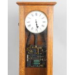 A Synchronome electric master clock, the silvered circular dial with black Roman hour numerals and