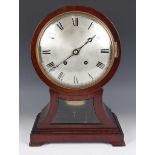 An early 20th century mahogany balloon cased mantel clock with eight day movement striking on two