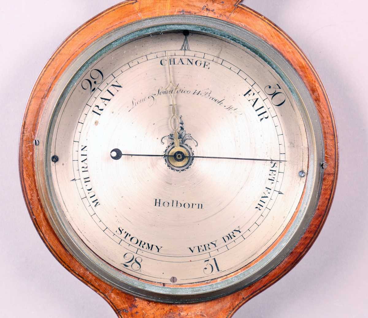 An early 19th century mahogany wheel barometer with silvered dial, inscribed 'Lione & Somalvico 14