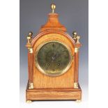 An early 20th century oak cased mantel clock with eight day movement striking on a gong, the 6-