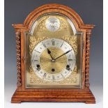 A George V oak mantel clock with eight day movement striking and chiming on gongs, the brass