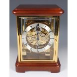 A 20th century German lacquered brass and mahogany four glass mantel clock by Kieninger, the eight