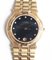 A Gucci 9200M Quartz gilt metal gentleman's bracelet wristwatch with signed black dial, the