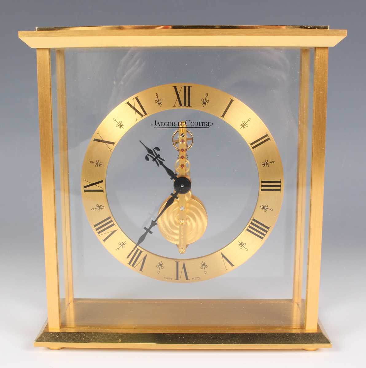 A Jaeger-LeCoultre gilt brass mantel timepiece, the brass chapter ring with black Roman hour