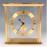 A Jaeger-LeCoultre gilt brass mantel timepiece, the brass chapter ring with black Roman hour