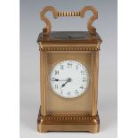 A late 19th/early 20th century lacquered brass carriage clock, the eight day movement striking hours