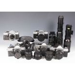 A collection of assorted cameras, lenses and accessories, including a Praktica Super TL2 camera with