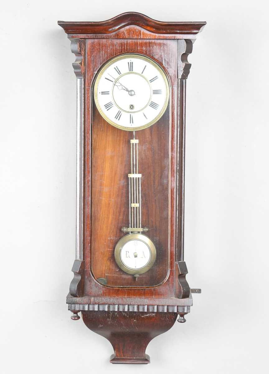 A late 19th century simulated rosewood cased Vienna style wall timepiece with single train movement,