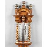 A 20th century Queen Anne style walnut stick barometer with arched surmount, ball finials, barley