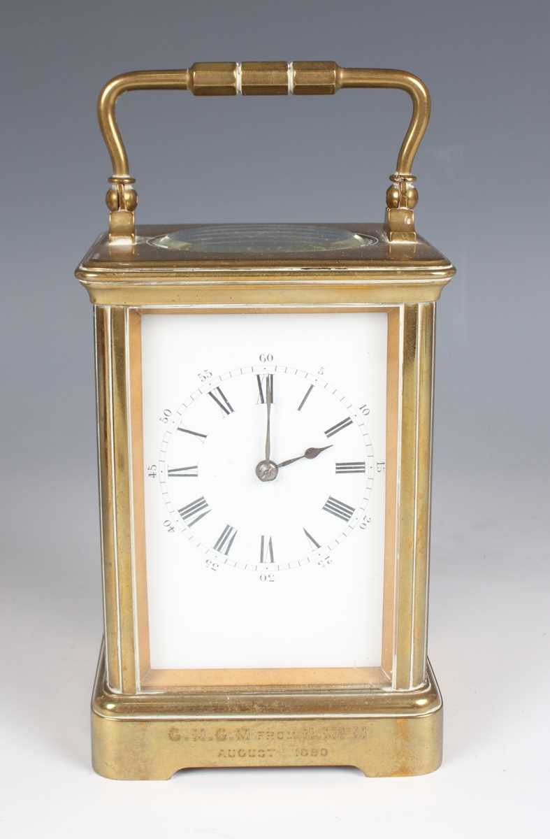 A late 19th century French brass corniche cased carriage clock with eight day movement striking on a