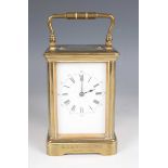 A late 19th century French brass corniche cased carriage clock with eight day movement striking on a