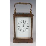 A late 19th/early 20th century French brass cased carriage clock with eight day movement striking on
