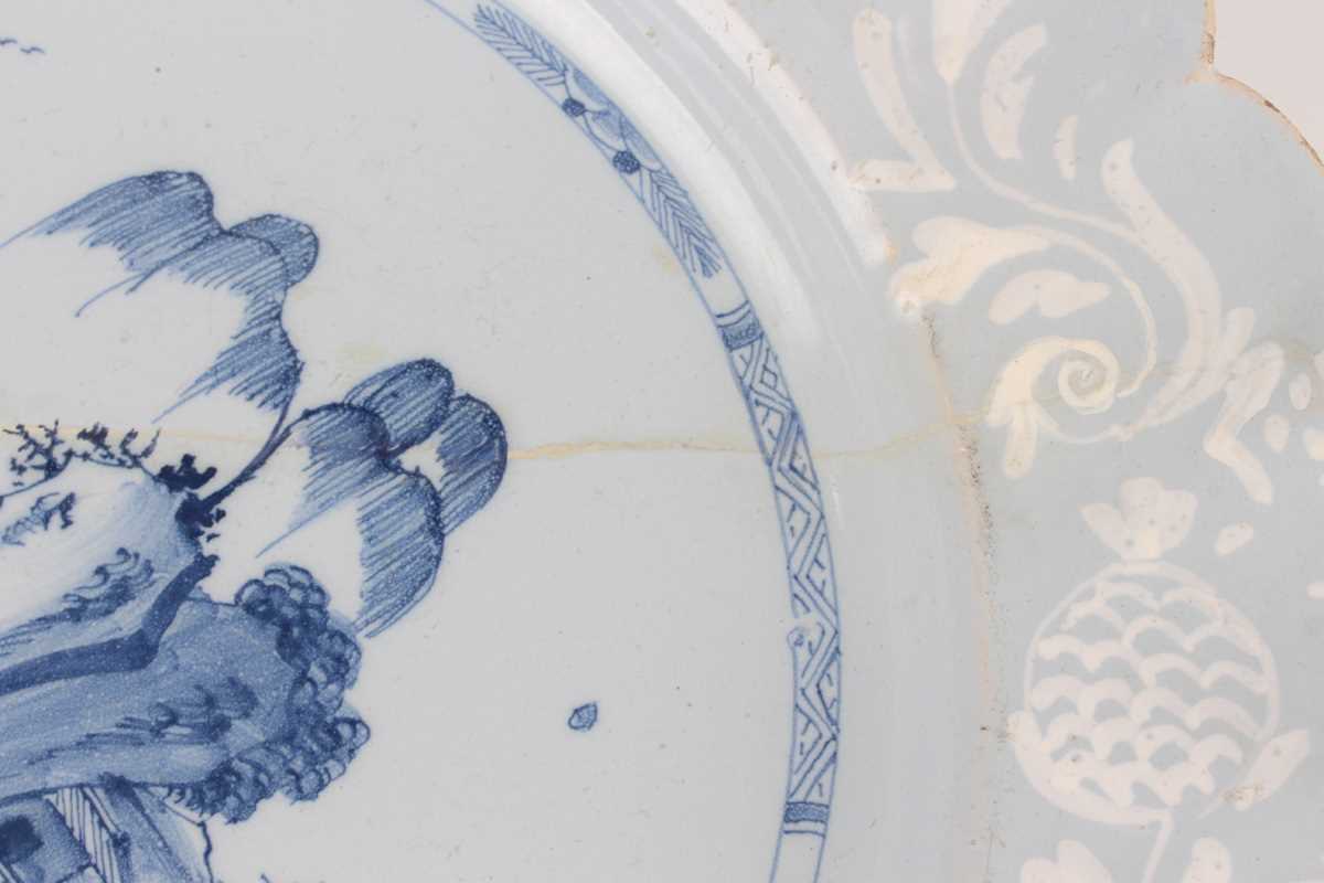 A manganese powdered ground delft dish, Bristol or Wincanton, circa 1740, painted in blue with a - Image 18 of 21