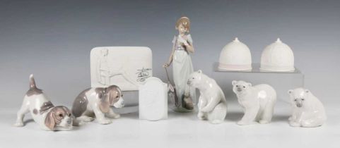 Three Lladro polar bears, two Lladro puppies, the Lladro Collector's Society figure Summer Stroll,