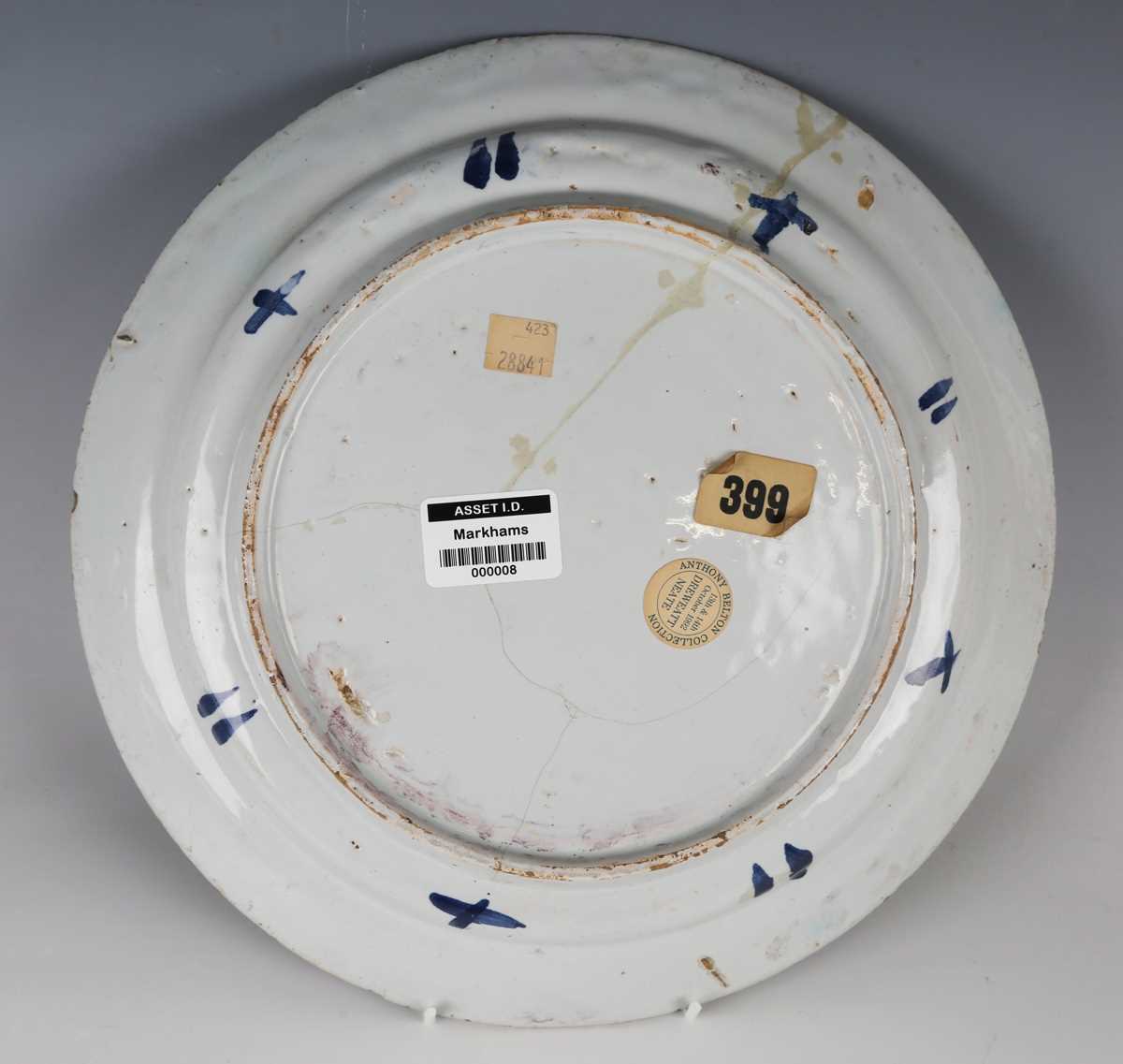 A manganese powdered ground delft dish, Bristol or Wincanton, circa 1740, painted in blue with a - Image 4 of 21
