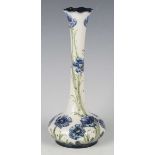 A Macintyre Moorcroft Florian Ware Poppy pattern vase, circa 1903-04, with blue flowers against a