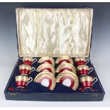 An Aynsley bone china cased set of six coffee cups and saucers, with six enamelled silver coffee