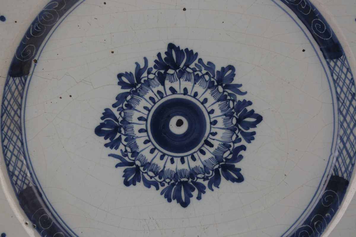 A manganese powdered ground delft dish, Bristol or Wincanton, circa 1740, painted in blue with a - Image 7 of 21