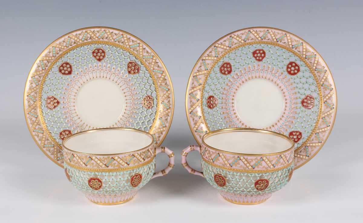 A pair of Royal Worcester reticulated cups and saucers, circa 1876, of double-walled construction,