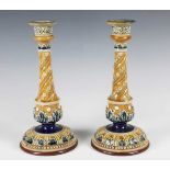 A pair of Doulton Lambeth candlesticks, late 19th century, decorated by Emily Partington,