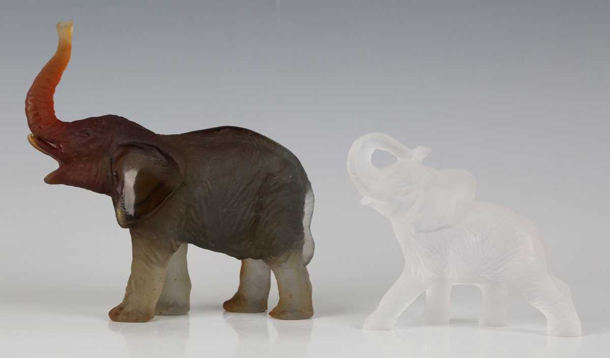 A Daum frosted amber glass model of an elephant with raised trunk, contemporary, designed by Jean-