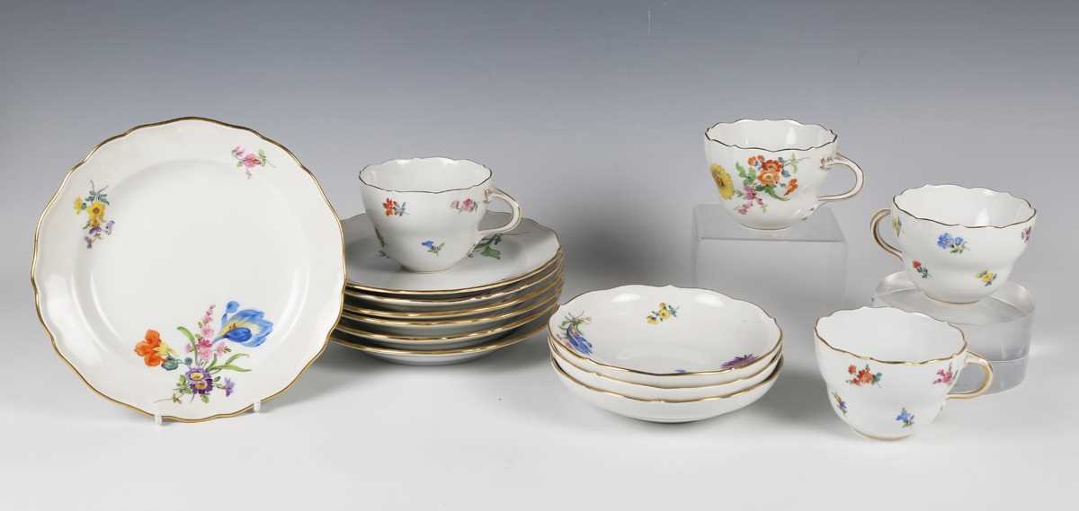 A small group of Meissen teawares, 20th century, painted with scattered flowers, comprising three