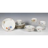 A small group of Meissen teawares, 20th century, painted with scattered flowers, comprising three