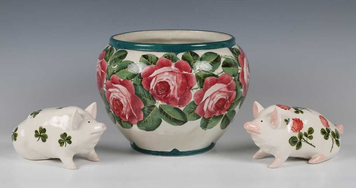 Two Griselda Hill Pottery Wemyss style small pigs, the first painted with shamrock, the second