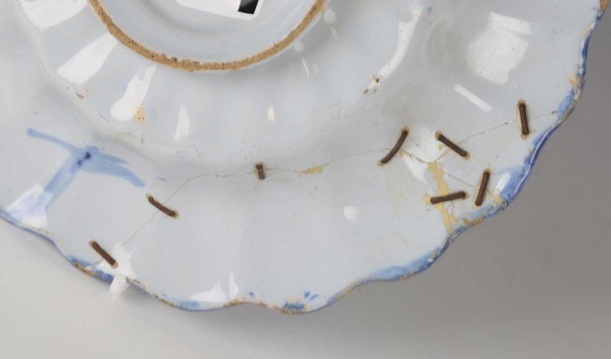 A Dutch Delft lobed buckle dish, circa 1700, painted in blue and yellow with Chinese figures to - Image 4 of 13