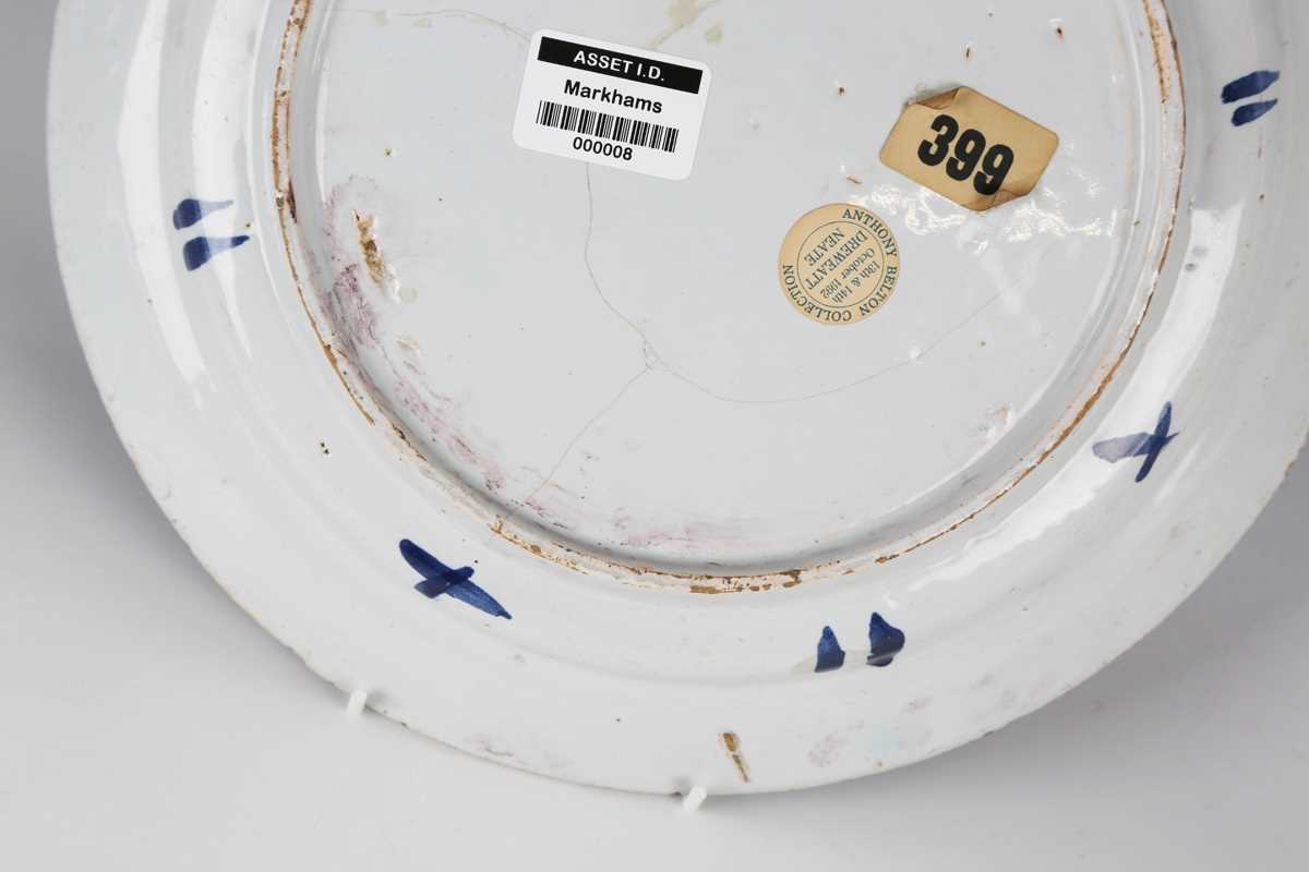 A manganese powdered ground delft dish, Bristol or Wincanton, circa 1740, painted in blue with a - Image 5 of 21