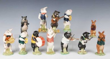 Twelve Beswick Pig Promenade figures, comprising two limited edition examples produced for