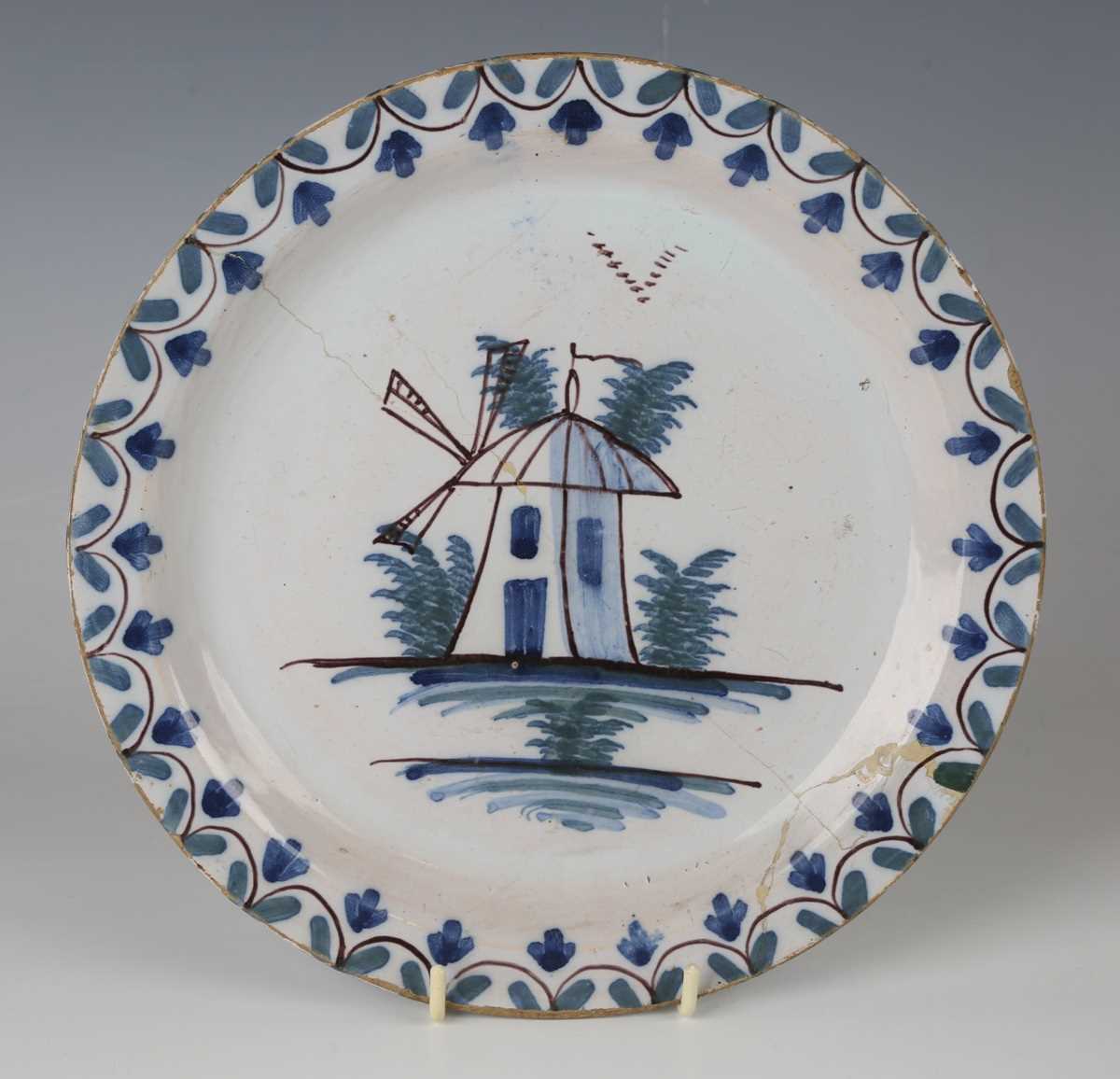 An English delft plate, Lambeth, circa 1770-85, painted in blue, green and manganese with a windmill - Image 4 of 23