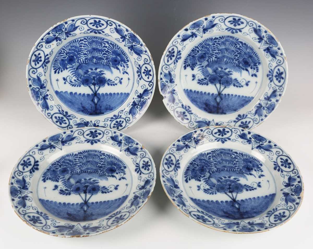 A set of four Dutch delft plates, late18th/19th century, each painted in blue with a central 'tea
