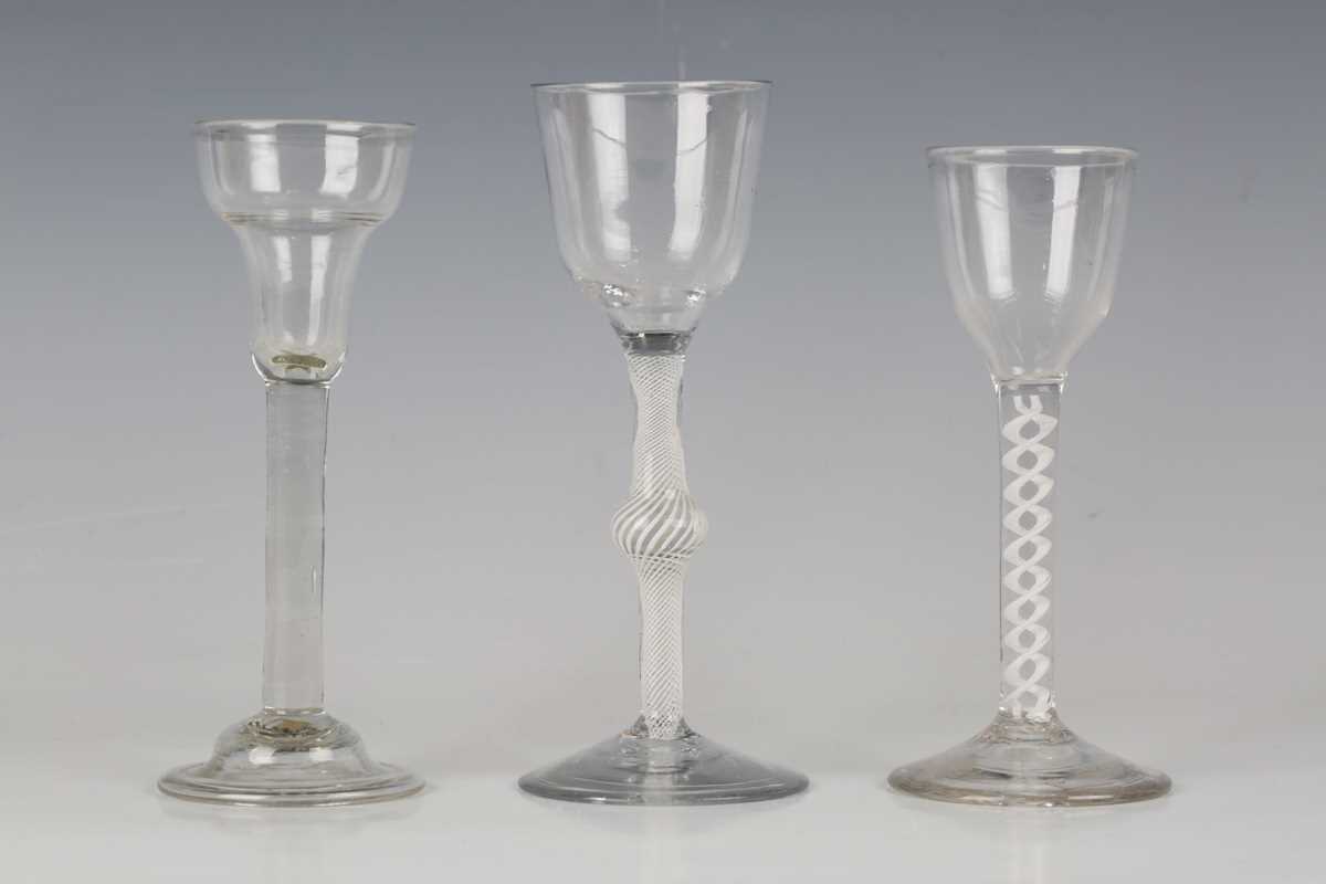 A pan-topped plain stem wine glass, circa 1740, with domed foot, height 16cm, together with two