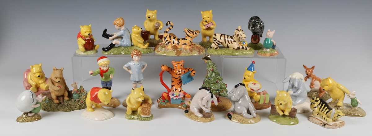 Twenty-four Royal Doulton Winnie The Pooh Collection figures, including three Christmas themed