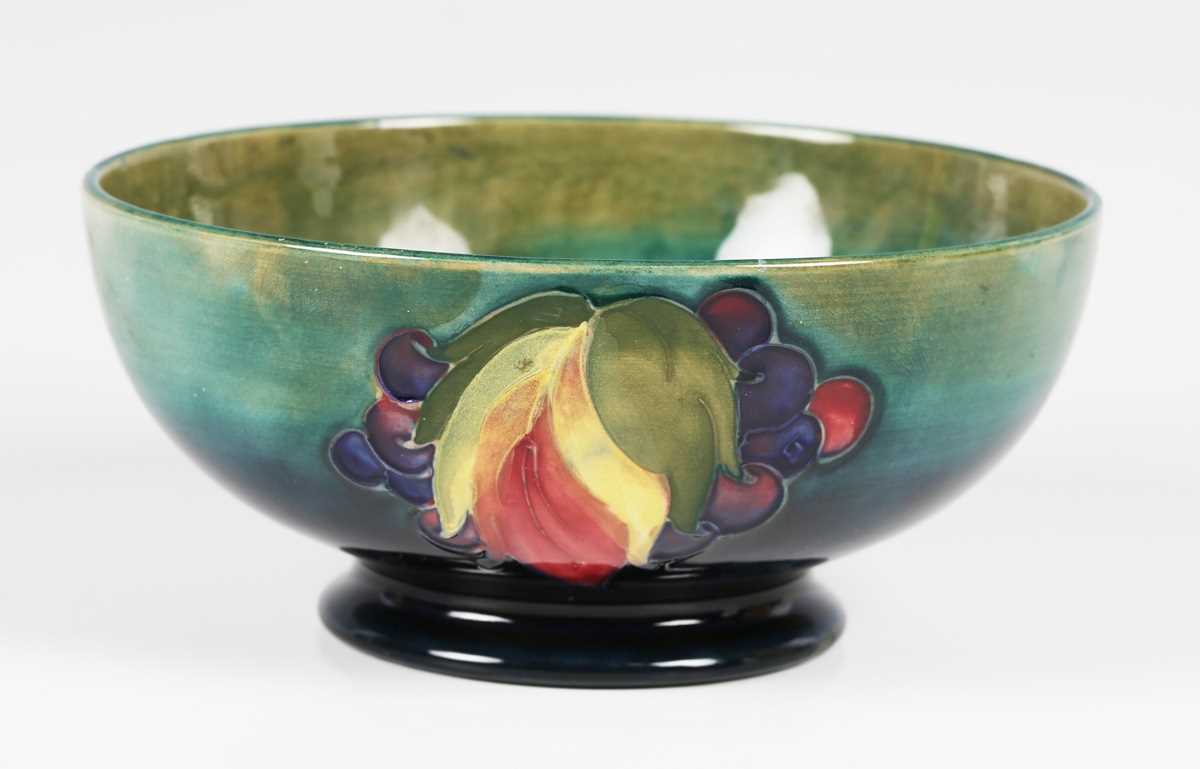 A Moorcroft Leaf and Berry pattern circular bowl, circa 1940, with shaded blue to green ground,