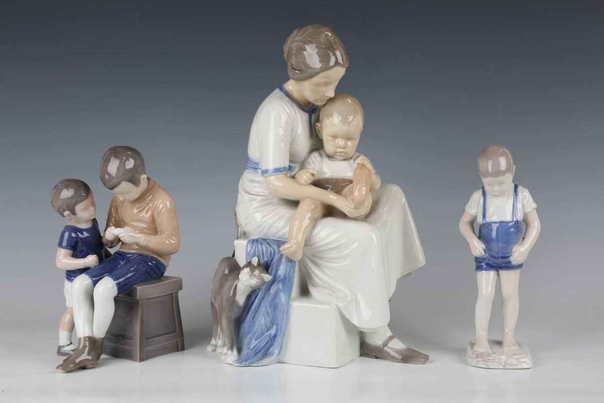 A large Bing & Grondahl porcelain model of a mother and child, shape No. 1829, seated on steps