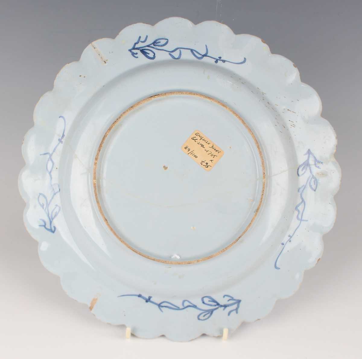 A manganese powdered ground delft dish, Bristol or Wincanton, circa 1740, painted in blue with a - Image 15 of 21