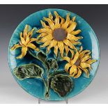 A Salopian Decorative Art Pottery circular charger, circa 1900, decorated in high relief with yellow