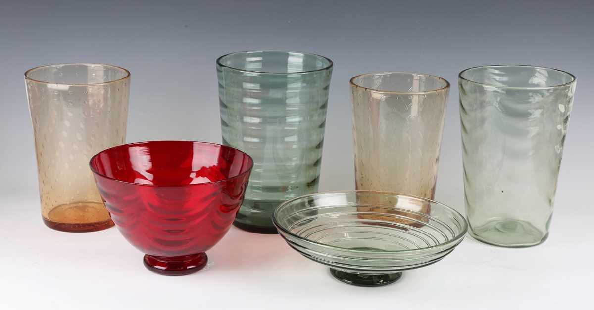 A Whitefriars ruby tint wave-ribbed footed bowl, the shape designed by William Butler in the