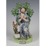 A Staffordshire pearlware figure of St. Peter, early 19th century, modelled kneeling before