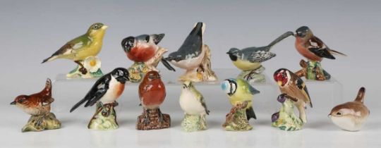 Eleven small Beswick bird models, including Bullfinch, Wren, Blue Tit and Goldfinch.