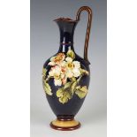 A Doulton Lambeth faience jug, circa 1885, decorated by Elizabeth Shelley, monogrammed, with a