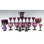 A mixed group of amethyst coloured glassware, mostly 19th century, including a set of eight wines